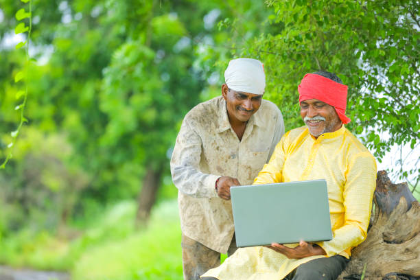 Farmers using laptop together