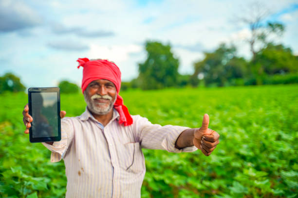 Farmer showing tablet in field